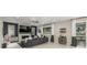 Beautiful living room with modern fireplace, large TV, gray sofa, and stylish decor at 4925 Coltin Trl, Castle Rock, CO 80104