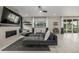 Cozy living room featuring a fireplace, large windows, and an adjacent kitchen area at 4925 Coltin Trl, Castle Rock, CO 80104