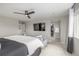 Spacious main bedroom featuring a ceiling fan, TV, and an ensuite bathroom with walk-in closet at 4925 Coltin Trl, Castle Rock, CO 80104