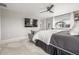 Serene bedroom with a cozy gray sofa, a large TV, and plenty of space for relaxation and comfort at 4925 Coltin Trl, Castle Rock, CO 80104