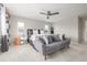 Bright bedroom featuring a gray sofa, neutral decor, and ample natural light for a peaceful ambiance at 4925 Coltin Trl, Castle Rock, CO 80104