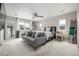 Spacious bedroom with gray sofa, large windows, and natural light showcasing a tranquil retreat at 4925 Coltin Trl, Castle Rock, CO 80104