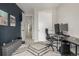 Modern office featuring a desk with dual monitors, a sliding door closet, and geometric patterned rug at 4925 Coltin Trl, Castle Rock, CO 80104
