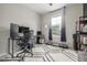 Bright office space with a large window, a desk with dual monitors, and a modern patterned rug at 4925 Coltin Trl, Castle Rock, CO 80104