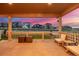 Covered patio featuring neutral furniture and a serene view of the beautiful neighborhood during sunset at 4925 Coltin Trl, Castle Rock, CO 80104