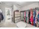 Large walk-in closet with built-in storage, shelving, ottoman and access to a modern bathroom at 4925 Coltin Trl, Castle Rock, CO 80104