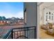 Balcony view showcasing city skyline, with an open door to a modernly furnished interior at 1521 Central St # 3C, Denver, CO 80211