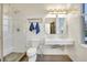 Modern bathroom featuring white tile, glass shower, and floating sink at 1521 Central St # 3C, Denver, CO 80211