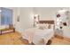 Light filled bedroom with hardwood floors, stylish decor, and large windows at 1521 Central St # 3C, Denver, CO 80211