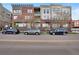 A modern condo complex showing a mix of brick and concrete with street parking at 1521 Central St # 3C, Denver, CO 80211