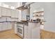 Modern kitchen showcasing stainless steel appliances, island cooktop, and custom shelving at 1521 Central St # 3C, Denver, CO 80211