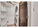 Functional laundry area featuring a stacked washer and dryer, and storage shelves at 1521 Central St # 3C, Denver, CO 80211