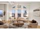 Bright living room featuring a modern chandelier, city views, and stylish furniture at 1521 Central St # 3C, Denver, CO 80211