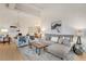 Spacious open-concept living area with hardwood floors and modern chandelier and view to the kitchen at 1521 Central St # 3C, Denver, CO 80211