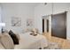 Bright main bedroom with barn door, neutral color scheme, and wood floors at 1521 Central St # 3C, Denver, CO 80211