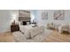 Calm main bedroom, with wood floors, a tray with books on the bed, and reading chairs at 1521 Central St # 3C, Denver, CO 80211