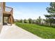 Spacious backyard with lush grass, deck, patio, and scenic views at 7120 Red Mesa Dr, Littleton, CO 80125
