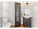 This half-bath includes a toilet, sink, and decorative cabinet at 7120 Red Mesa Dr, Littleton, CO 80125