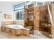 Bathroom featuring a soaking tub and tiled shower at 7120 Red Mesa Dr, Littleton, CO 80125