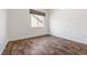 This bedroom has wood-look flooring and a large window at 7120 Red Mesa Dr, Littleton, CO 80125