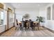 Dining room with hardwood floors, neutral decor and large windows allowing for lots of natural light at 7120 Red Mesa Dr, Littleton, CO 80125