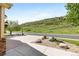 Landscaped front yard featuring xeriscape design elements with a view of a hill in the distance at 7120 Red Mesa Dr, Littleton, CO 80125