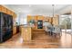 Spacious kitchen with wood cabinets, stainless steel appliances, and adjacent dining area with outdoor access at 7120 Red Mesa Dr, Littleton, CO 80125