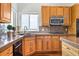 Kitchen area featuring wood cabinets, laminate counter tops and stainless steel microwave at 7120 Red Mesa Dr, Littleton, CO 80125