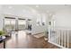 Bright living room with hardwood floors, white walls, neutral decor, and large windows overlooking the outdoors at 7120 Red Mesa Dr, Littleton, CO 80125