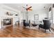 Bright living room featuring a fireplace, ceiling fan, and elegant furnishings, on hardwood floors at 7120 Red Mesa Dr, Littleton, CO 80125