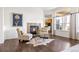 Comfortable living room showcasing a cozy fireplace, hardwood floors, and a view into the kitchen at 7120 Red Mesa Dr, Littleton, CO 80125