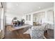 Open concept living room flowing into the dining room, featuring hardwood floors, neutral decor and large windows at 7120 Red Mesa Dr, Littleton, CO 80125