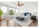 Bright main bedroom featuring a ceiling fan and large windows offering serene outdoor views at 7120 Red Mesa Dr, Littleton, CO 80125