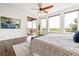Sunny main bedroom with backyard access, hardwood floors, ceiling fan and great light at 7120 Red Mesa Dr, Littleton, CO 80125