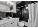 Bathroom featuring a black tile shower and sink at 7940 Appleblossom Ln, Westminster, CO 80030
