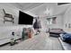 Cozy bedroom with a television, window, tile floor, and other furniture and items at 7940 Appleblossom Ln, Westminster, CO 80030
