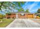 Charming brick home with well-maintained lawn and a large concrete driveway at 7940 Appleblossom Ln, Westminster, CO 80030