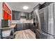 Efficient kitchen with dark cabinetry, laminate floors, and stainless steel appliances at 7940 Appleblossom Ln, Westminster, CO 80030