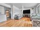 Spacious living room with modern decor, hardwood floors, and large-screen TV at 7940 Appleblossom Ln, Westminster, CO 80030