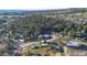 Overhead view of a neighborhood featuring many houses nestled among tall trees at 91 Greeley Blvd, Palmer Lake, CO 80133