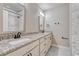 Bathroom featuring dual sinks with granite countertop and a shower at 91 Greeley Blvd, Palmer Lake, CO 80133
