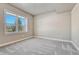 Neutral bedroom with plush carpeting and a view of evergreens through a window at 91 Greeley Blvd, Palmer Lake, CO 80133