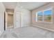 Neutral bedroom featuring a window with a backyard view and a closet at 91 Greeley Blvd, Palmer Lake, CO 80133