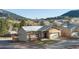 Attractive single-story house featuring a charming stone facade, stucco, and a well-maintained artificial lawn at 91 Greeley Blvd, Palmer Lake, CO 80133