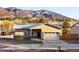 Inviting single-Gathering home with stucco and stone accents, set against a backdrop of picturesque mountains at 91 Greeley Blvd, Palmer Lake, CO 80133