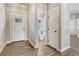 Bright entryway featuring wood-look tile flooring, crisp white trim, and a convenient powder room at 91 Greeley Blvd, Palmer Lake, CO 80133
