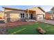 Charming single-story home featuring a stone facade, stucco siding, and a well-manicured artificial lawn at 91 Greeley Blvd, Palmer Lake, CO 80133