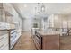 Spacious kitchen with a central island, granite countertops, stainless steel appliances, and wood-look tile flooring at 91 Greeley Blvd, Palmer Lake, CO 80133