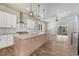 Bright, open kitchen featuring a large center island with granite countertops, white cabinets, and stainless appliances at 91 Greeley Blvd, Palmer Lake, CO 80133