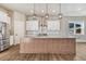 Well-appointed kitchen featuring a large island, granite counters, stainless steel appliances, and ample cabinet space at 91 Greeley Blvd, Palmer Lake, CO 80133